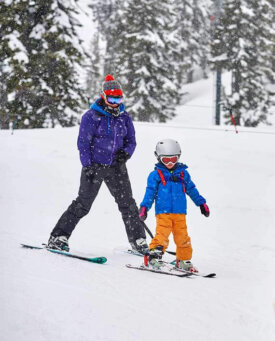 photo of mom and kid skiing